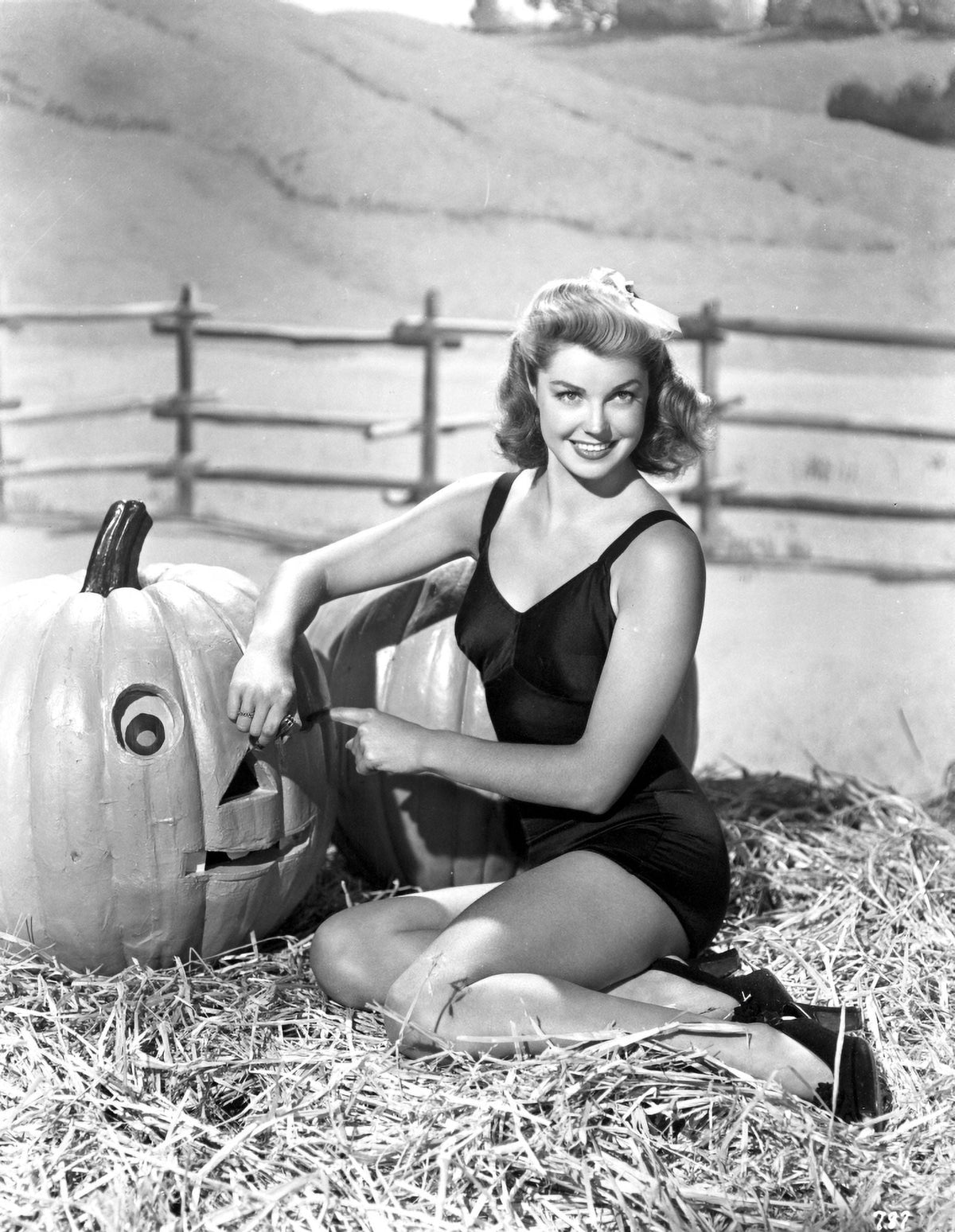 Esther Williams seated in hay photo print, classic Hollywood decor.