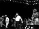 The Bee Gees on stage with John Travolta photo print.
