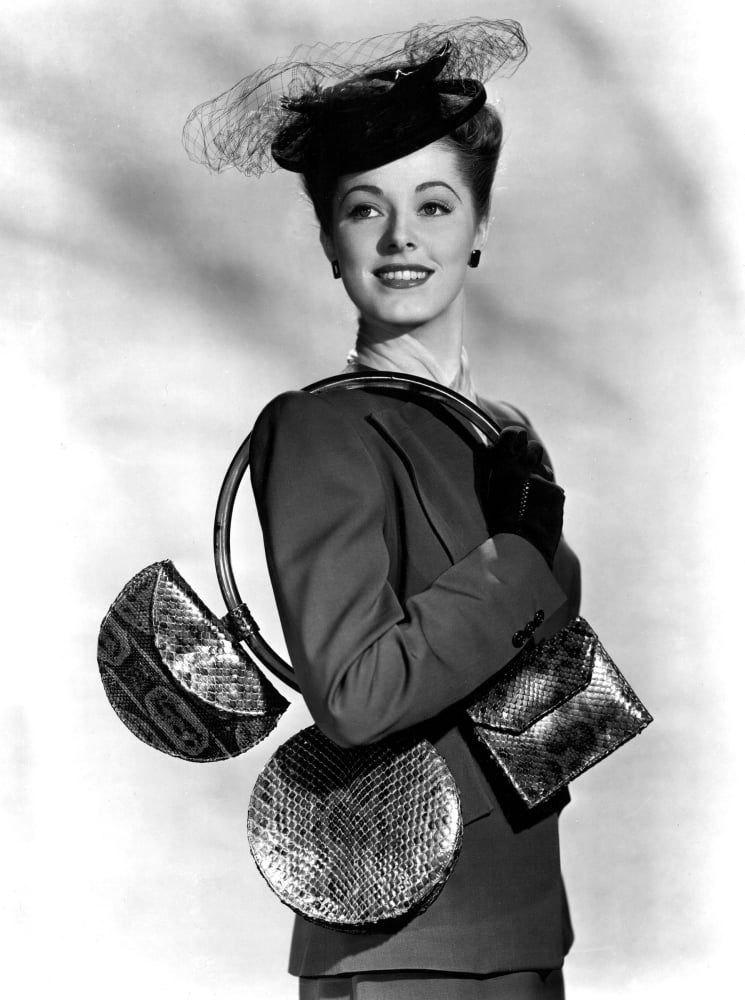 Eleanor Parker carrying handbags in vintage 1945 photo print.