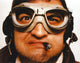 Close-up portrait photo of John Belushi wearing goggles