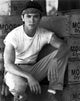 Lou Diamond Phillips crouching photo print, available in multiple sizes.