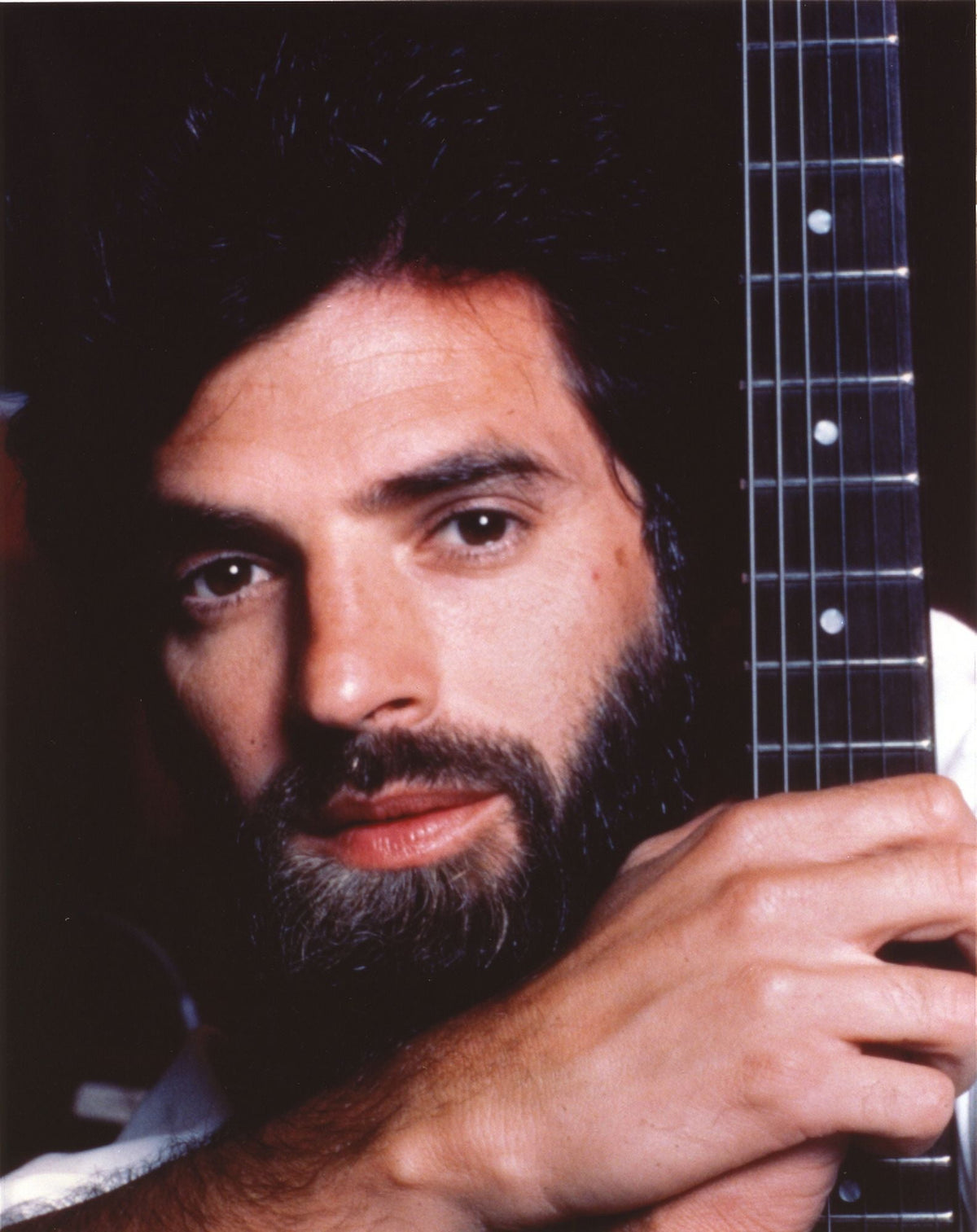 Close-up portrait photo print of Kenny Loggins playing guitar.