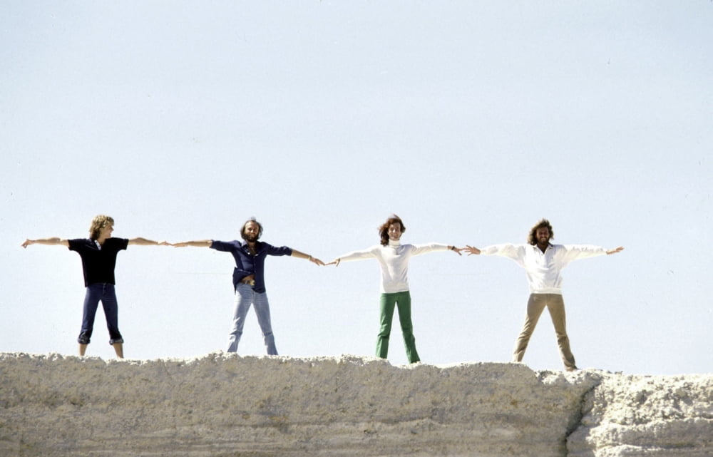 The Bee Gees posing on a cliff photo print showcasing iconic musicians.