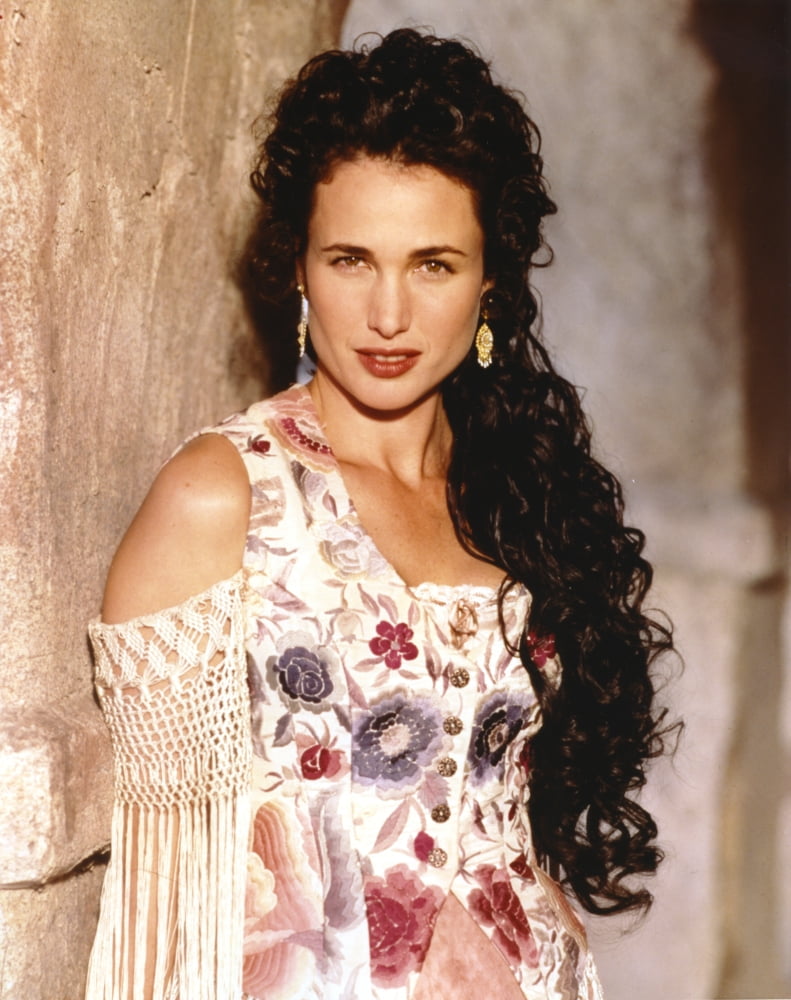 Andie MacDowell leaning on the wall wearing a floral dress with earrings photo print