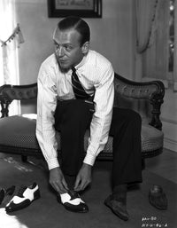 Fred Astaire seated on couch wearing shoe photo print