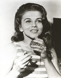 Ann-Margaret photo print smelling perfume - vintage charm.