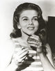 Ann-Margaret photo print smelling perfume - vintage charm.