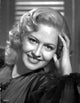 Close-up portrait photo print of Marilyn Maxwell in a black dress smiling.