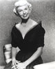 Doris Day seated in a classic pose wearing a black gown photo print