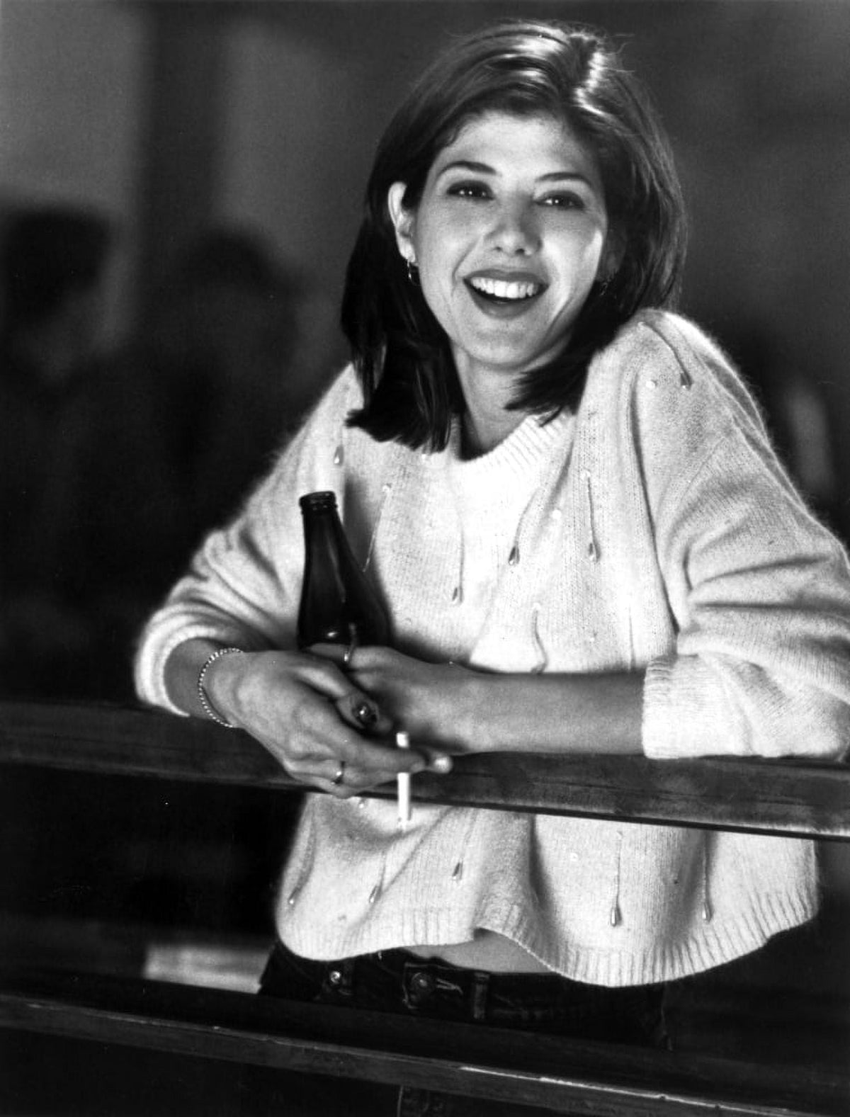 Marisa Tomei leaning in a white sweater holding a beer and cigarette photo print