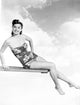 Esther Williams poised on a diving board photo print, showcasing classic Hollywood style.