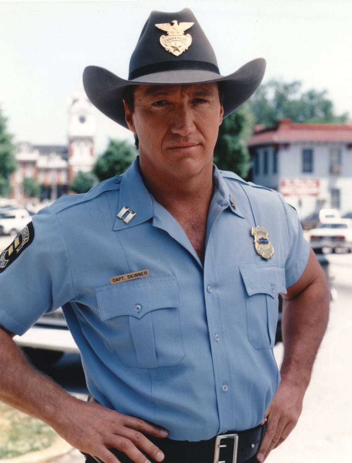 Alan Autry posed in police outfit photo print, capturing classic television nostalgia.