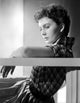 Jean Simmons leaning back in checkered short sleeve shirt photo print.