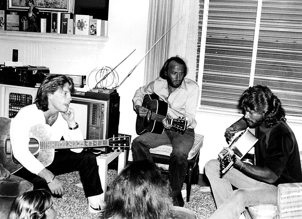 The Bee Gees playing guitars photo print, ideal for music lovers.