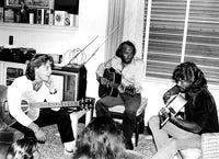 The Bee Gees playing guitars photo print, ideal for music lovers.