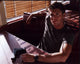 Jensen Ackles photo print in booth with gun on table.