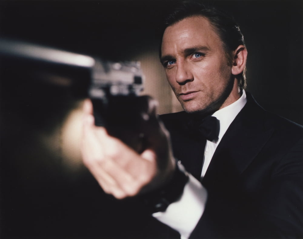 Daniel Craig firing pistol in black tuxedo photo print