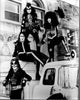 Black and white photo print of Kiss band on top of cars
