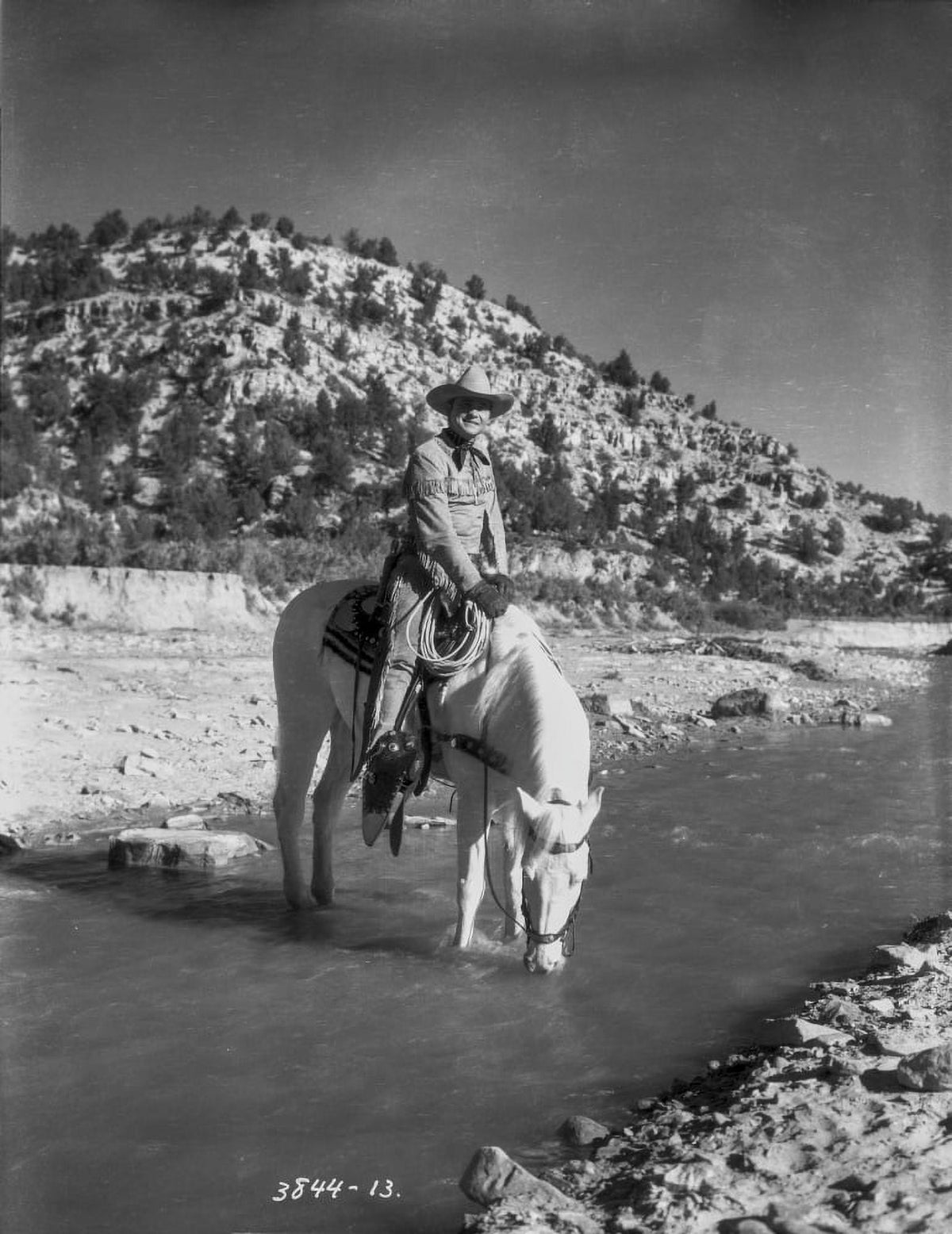 Tex Ritter on horseback in a river photo print