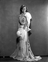Margaret Sullivan standing in white gown with hat photo print