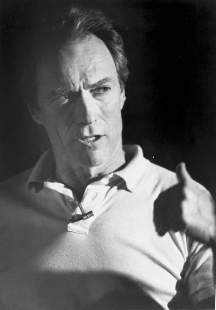 Clint Eastwood stylish portrait photo print in white sweater with black background.