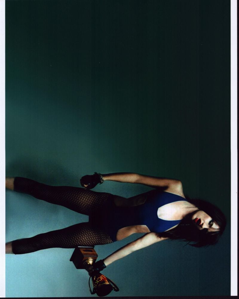 Juliette Lewis photo print in fishnets holding a trophy, available in multiple sizes.