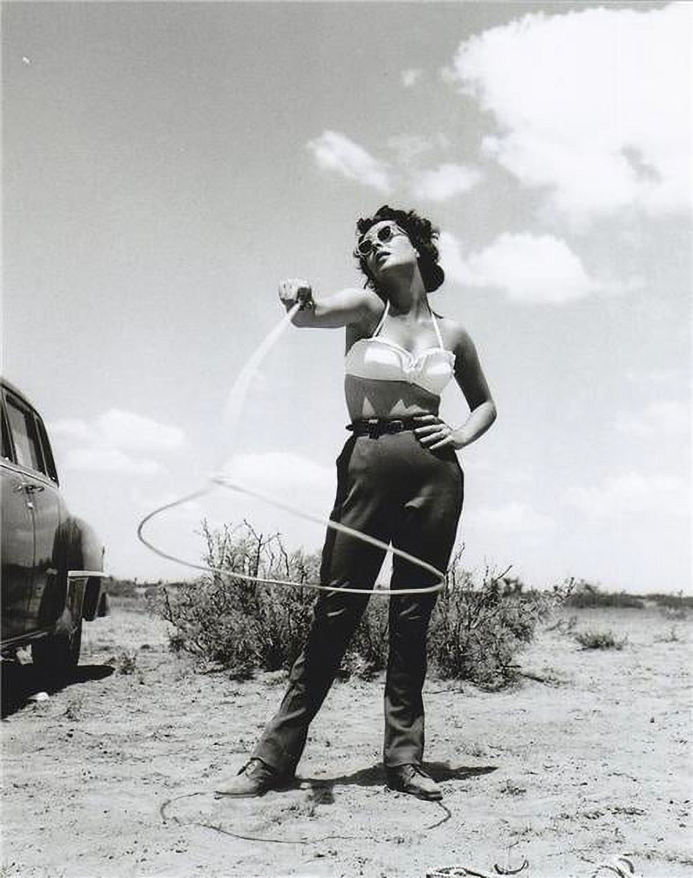 Elizabeth Taylor twirling lasso photo print, showcasing iconic Hollywood glamour.