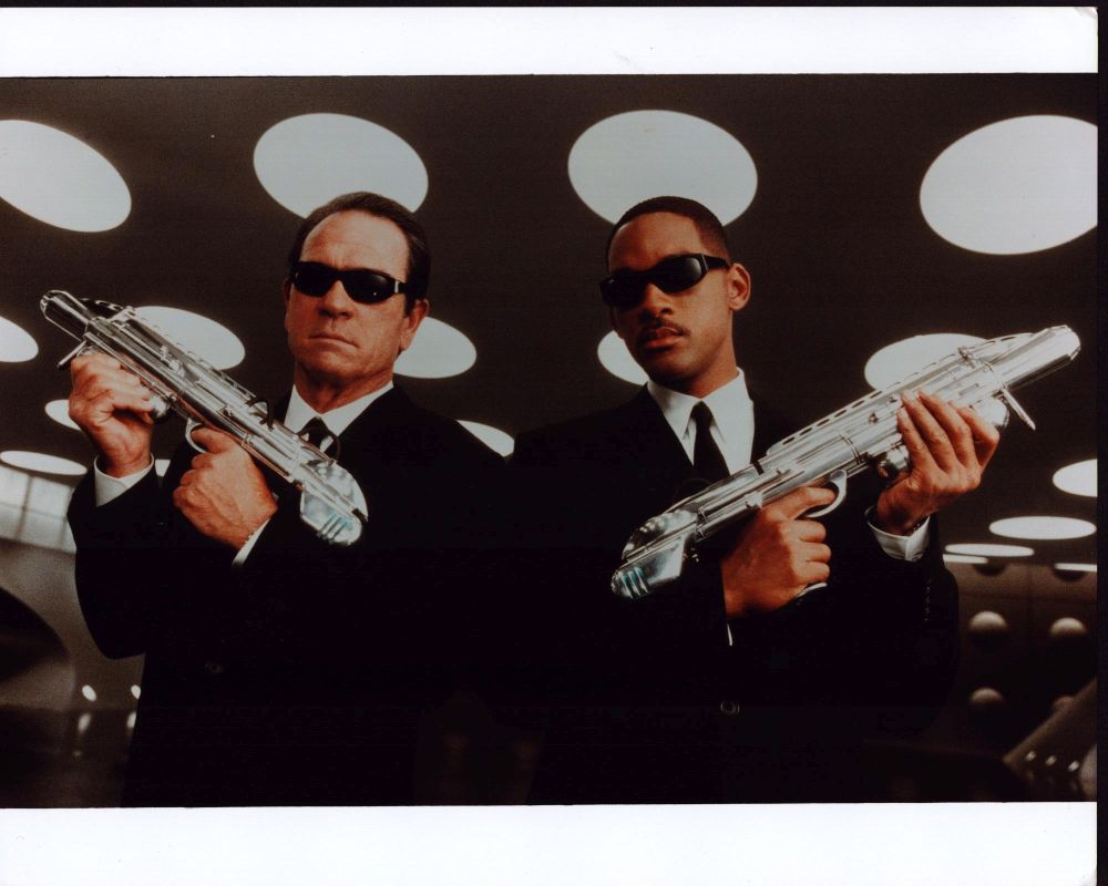 Men In Black photo print featuring Tommy Lee Jones and Will Smith holding guns.