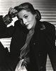 Joan Fontaine leaning in a black suit photo print