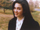 Close-up portrait photo print of Jennifer Connelly in black coat and white blouse.
