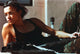Michelle Rodriguez lying on bed with rifle photo print