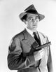 Classic portrait photo print of Sheldon Leonard in coat with pistol