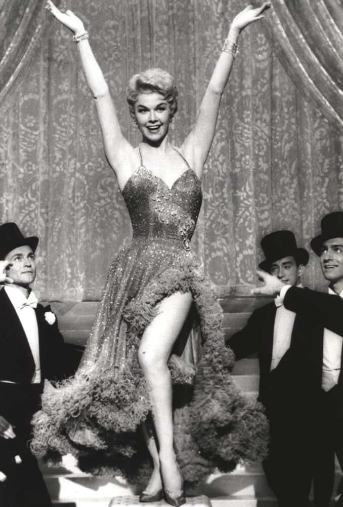 Doris Day dancing photo print with three men looking at her, capturing classic Hollywood charm.