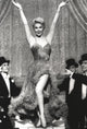 Doris Day dancing photo print with three men looking at her, capturing classic Hollywood charm.