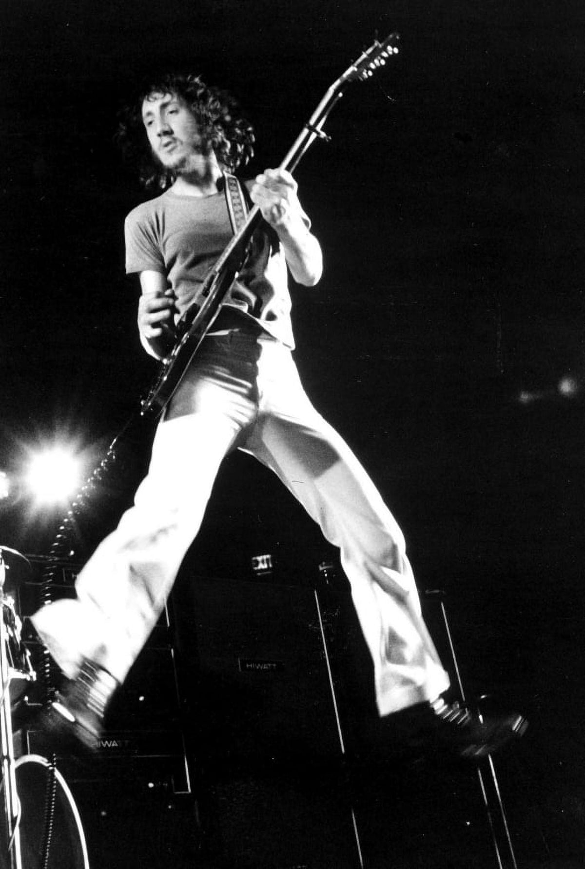 Dynamic photo print of Pete Townshend mid-jump during a performance.