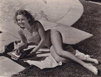 Betty Grable Writing Photo Print showcasing classic Hollywood elegance.