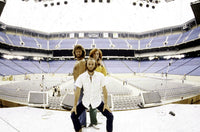 Bee Gees live performance photo print capturing the band on stage in an empty stadium.