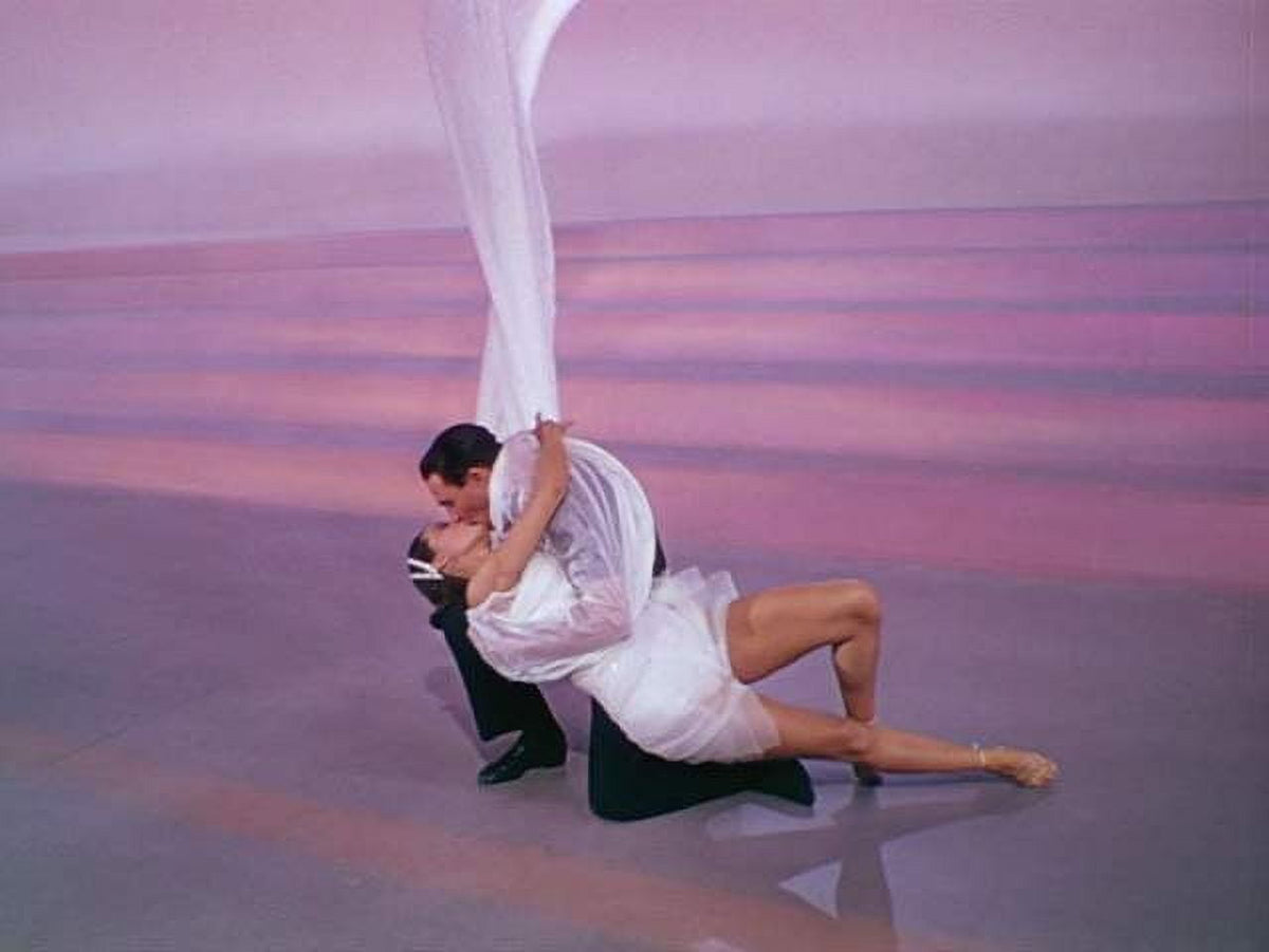 Cyd Charisse and Gene Kelly kissing photo print, capturing classic Hollywood romance.