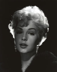 Close-up portrait photo print of Stella Stevens wearing a black fur coat in black and white.
