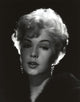 Close-up portrait photo print of Stella Stevens wearing a black fur coat in black and white.