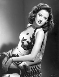 Carol Forman sitting in an embroidered halter dress photo print