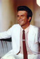 Photo print of Anthony Denison seated in white coat.