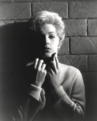 Black and white portrait of Stella Stevens wearing a turtle neck sweater.