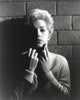 Black and white portrait of Stella Stevens wearing a turtle neck sweater.