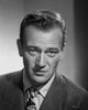 Classic John Wayne photo print in suit and tie, perfect for vintage cinema enthusiasts.