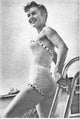 Debbie Reynolds holding onto a pool ladder photo print
