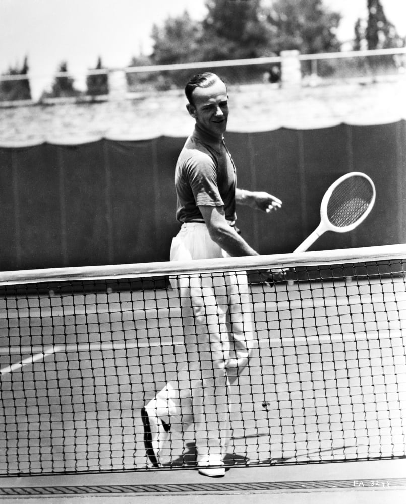 Fred Astaire playing tennis in a classic black and white portrait photo print.