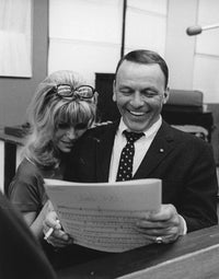 Nancy and Frank Sinatra smiling in a studio photo print.