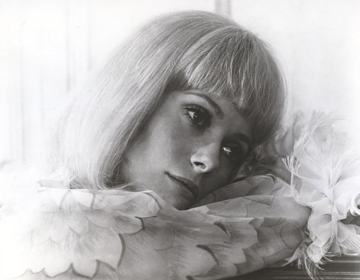 Catherine Deneuve wearing a stylish ruffled blouse photo print