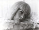 Catherine Deneuve wearing a stylish ruffled blouse photo print